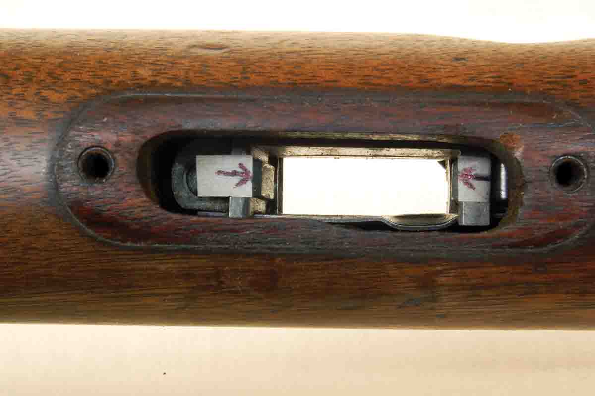 The arrows show the inside edges of the magazine lock, where wood fillers will end.